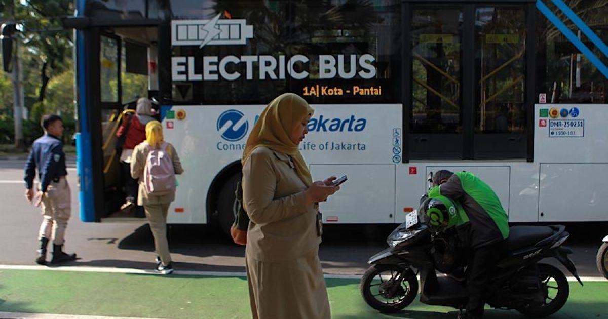 Pemandangan seorang Aparatur Sipil Negara (ASN) menunggu di halte bus Jalan Medan Merdeka Selatan, Jakarta, beberapa waktu lalu. (Foto Bloomberg Technoz/Andrean Kristianto)