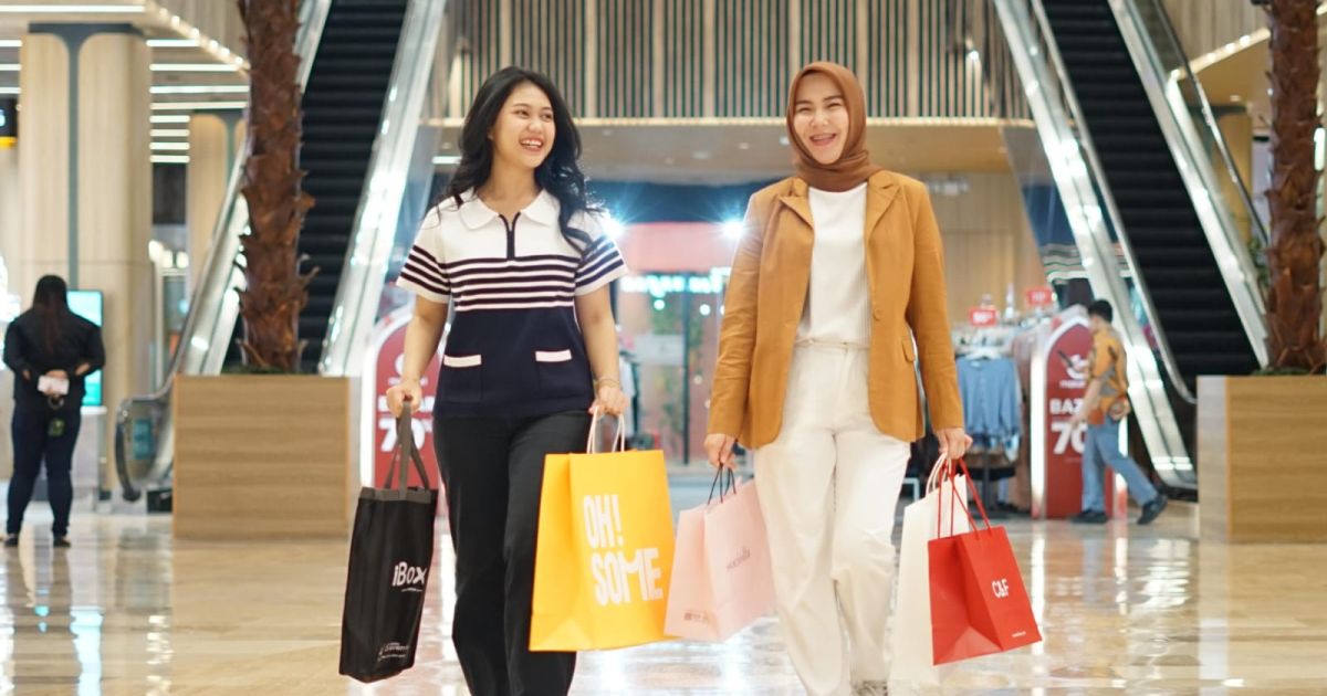 Seorang pedagang pasar tradisional menunjukkan kode QRIS kepada pembeli untuk melakukan transaksi pembayaran digital secara instan.
